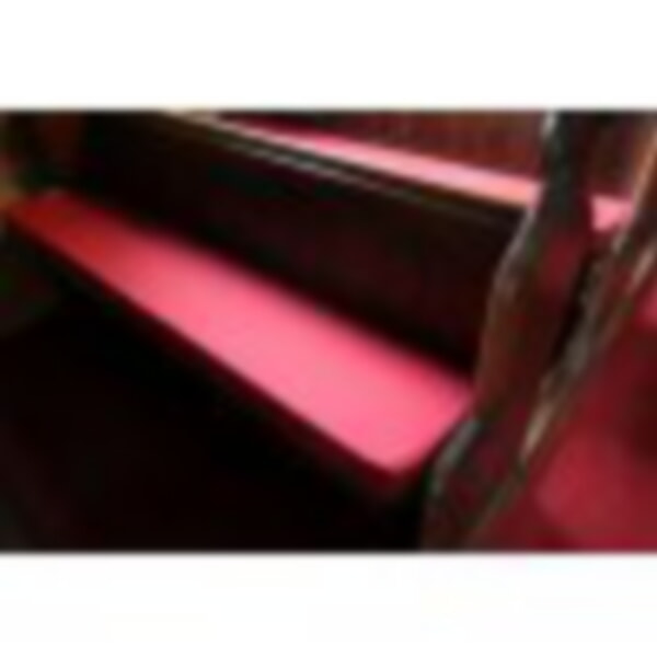 Old pews with new red cushions